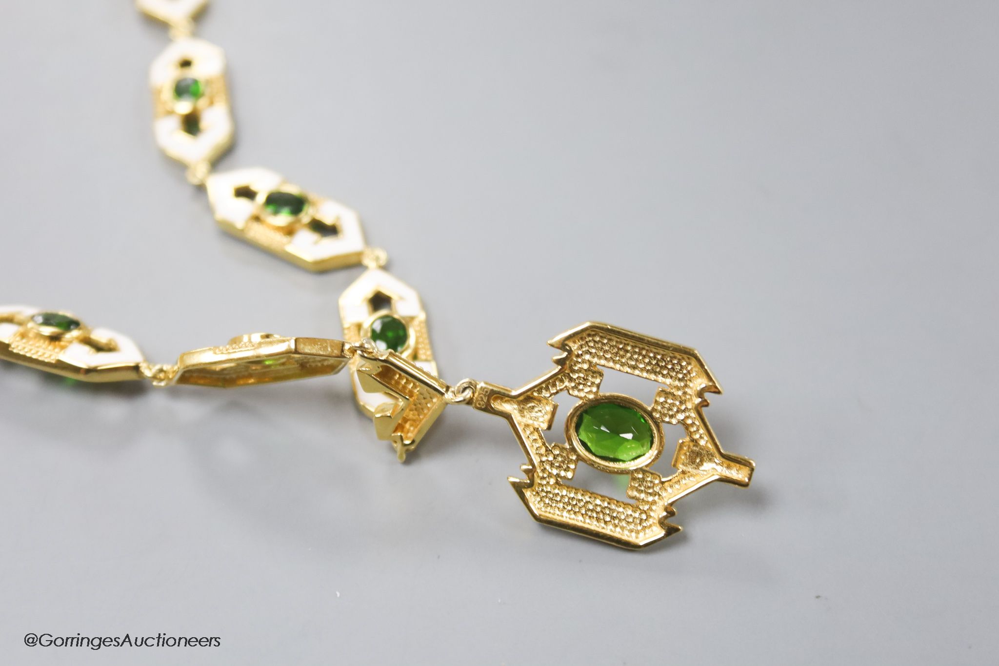 A modern stylish 925 gilt white metal, green paste and enamel set necklace, 50cm